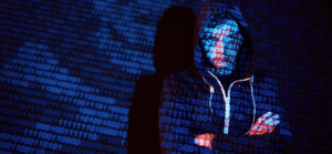 Cyber attack with unrecognizable hooded hacker using virtual reality, digital glitch effect.